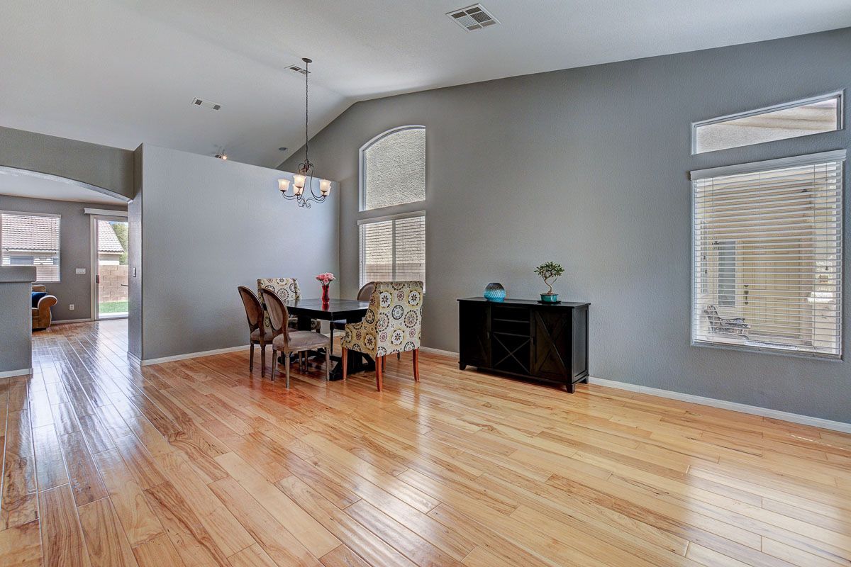 Formal living space with vaulted ceiling, large windors and hickory hardwood floors