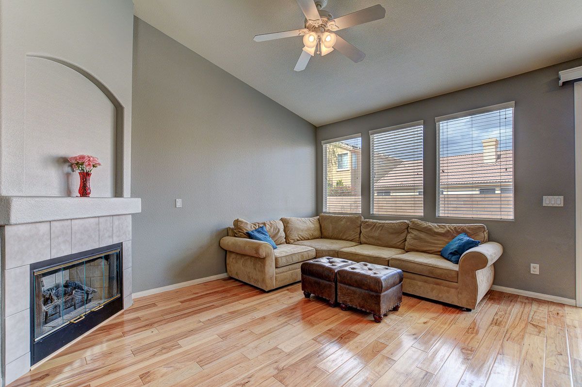 Living room with ceiling fan and gas fireplace