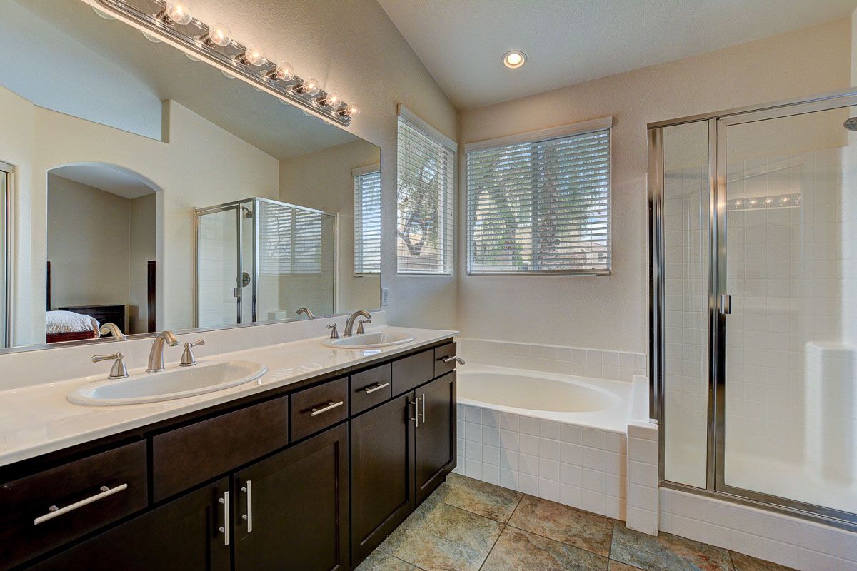 Master bath with double vanity and walk-in closet